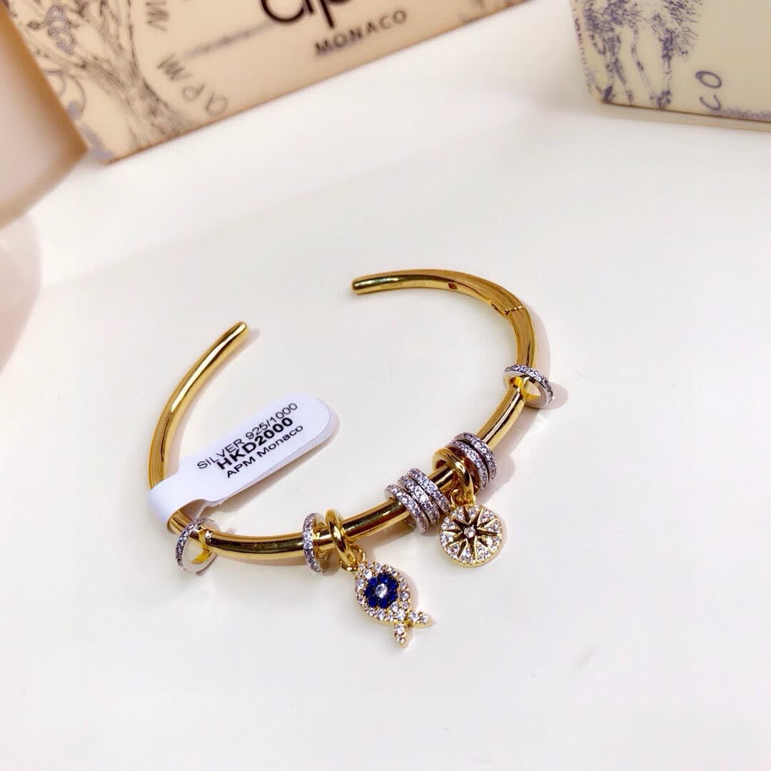 APM Monaco Gold Tone Bracelet with Fish and Star Charms